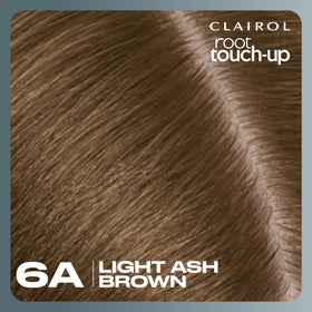 Clairol lifestyle shot of woman checking hair in mirror after touch-up for confidence