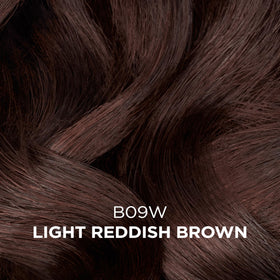 Clairol Professional color swatch on a hair strand showing natural light reddish brown tone
