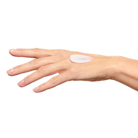 Clarins tube next to hand for scale and clear label for ingredient information