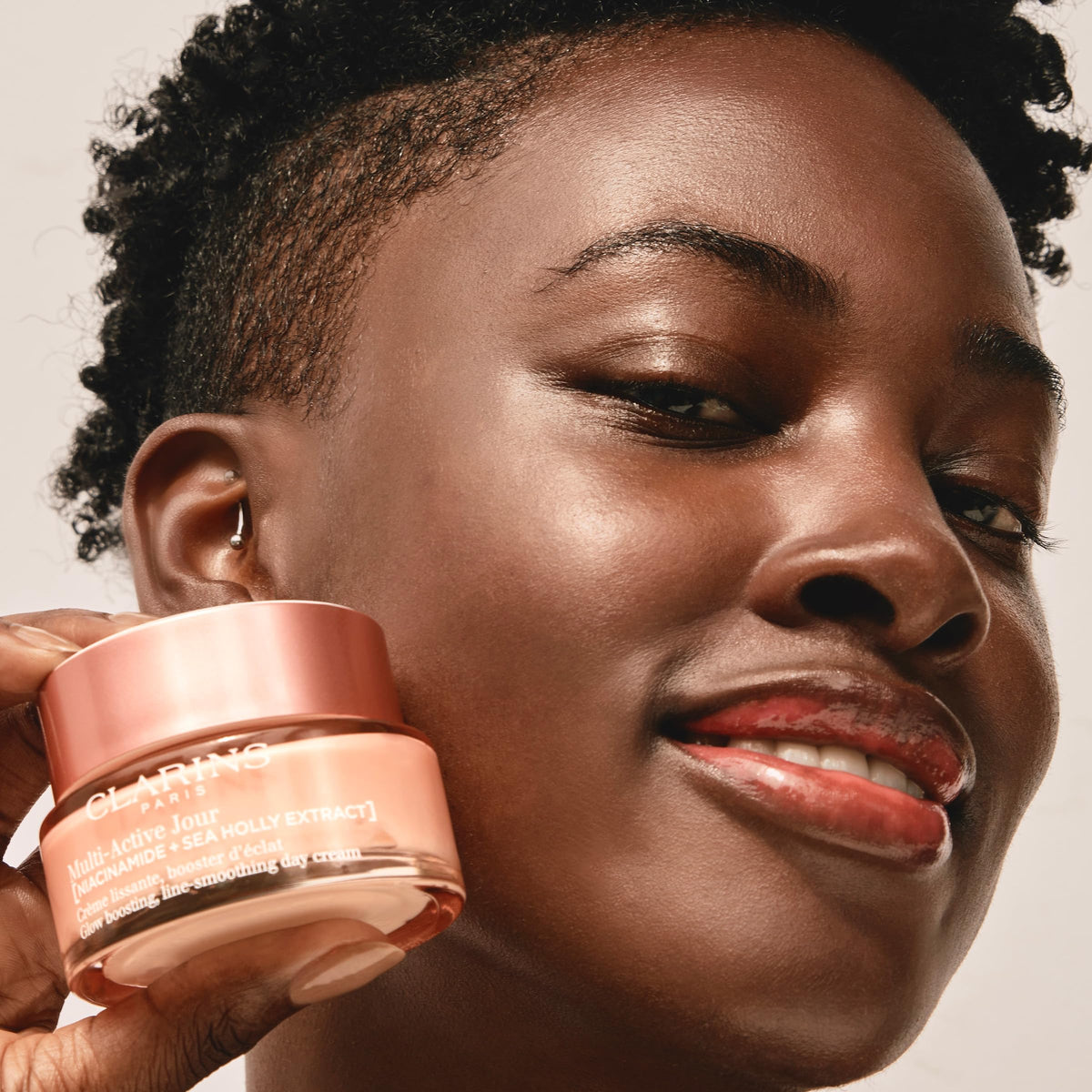 Clarins moisturizer on model in daylight showing refined pores and glow