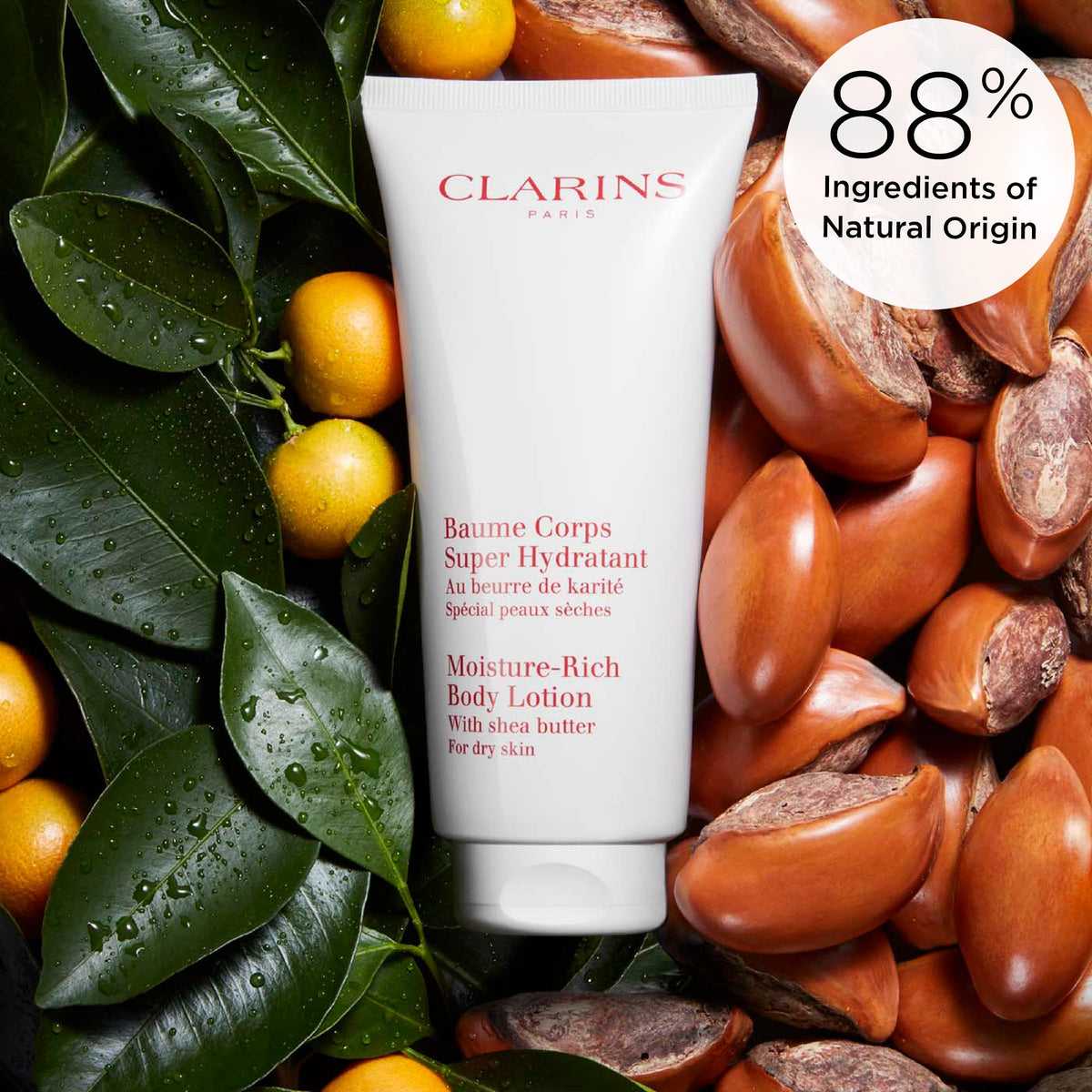 Clarins bottle beside everyday items showing size and convenience