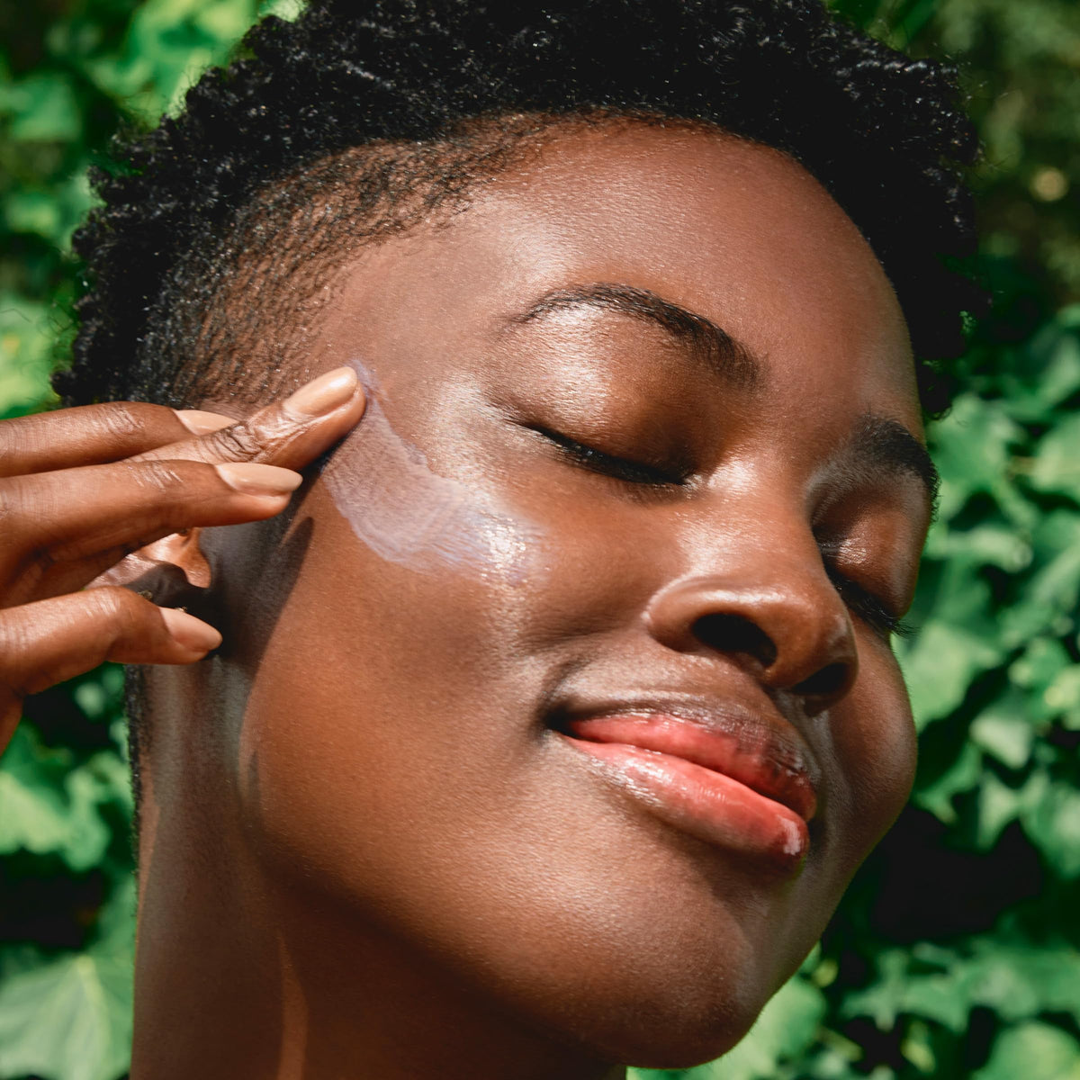 Clarins creamy sunscreen texture close-up demonstrating lightweight spreadability