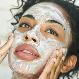 Clarins cleanser applied in hand demonstrating smooth spreadability benefit