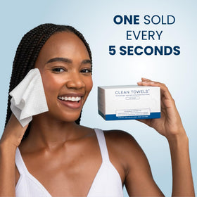 Clean Skin Club single towel held in hand to show scale and usability