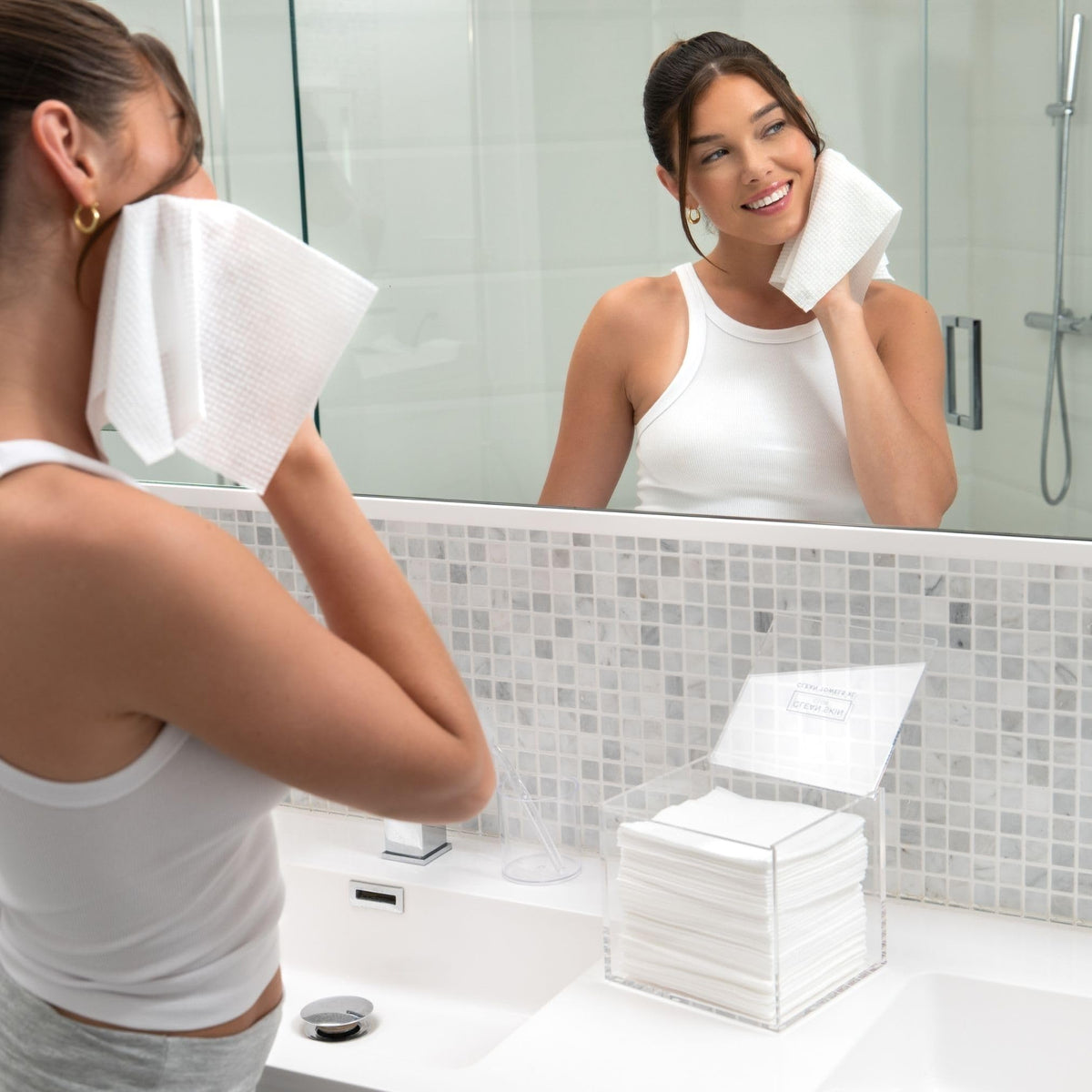 CLEAN SKIN CLUB next to a hand to show scale and portability benefit