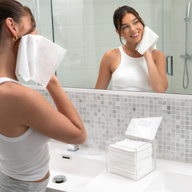 CLEAN SKIN CLUB next to a hand to show scale and portability benefit