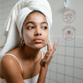 Clear Essence on hand being applied to a spot to visibly even complexion