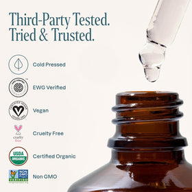 Hand holding Cliganic bottle to show 1oz scale and travel-friendly benefit