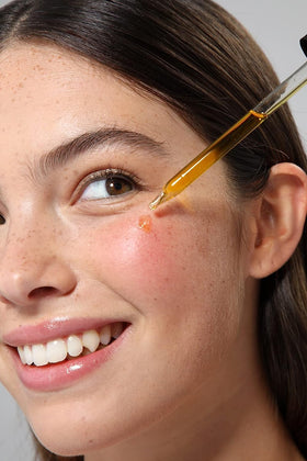 Hand applying Cliganic sea buckthorn oil to skin to boost hydration