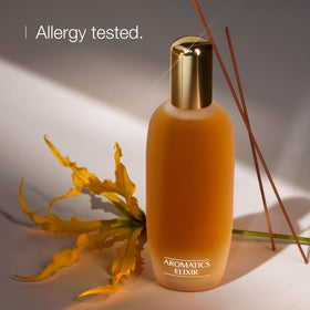 Clinique Aromatics Elixir bottle closeup label displaying brand and name benefit: authentic classic fragrance
