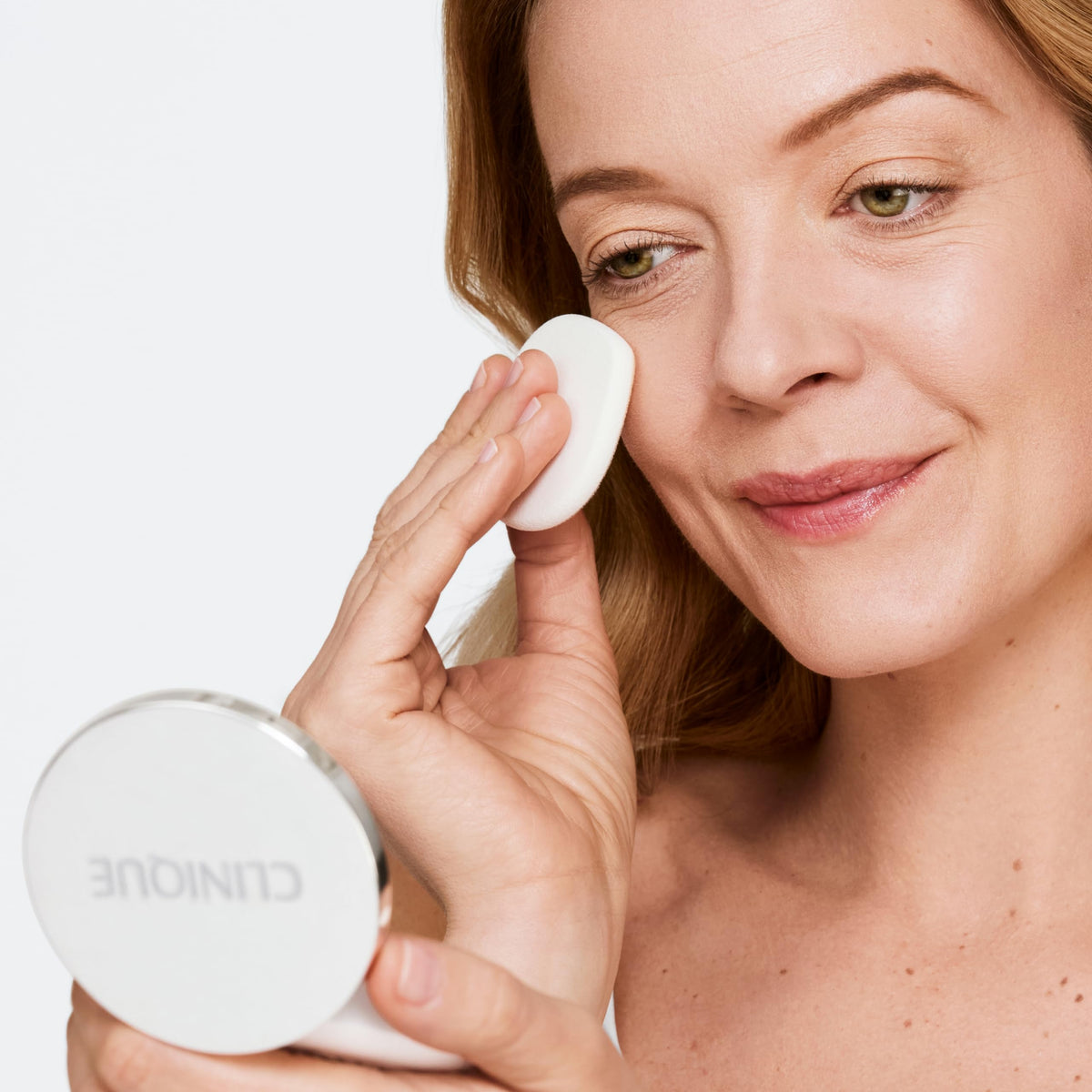 Clinique compact inside a handbag illustrating convenience for touch-ups on the go