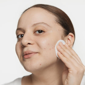 Clinique lotion applied with cotton pad, shows easy application benefit
