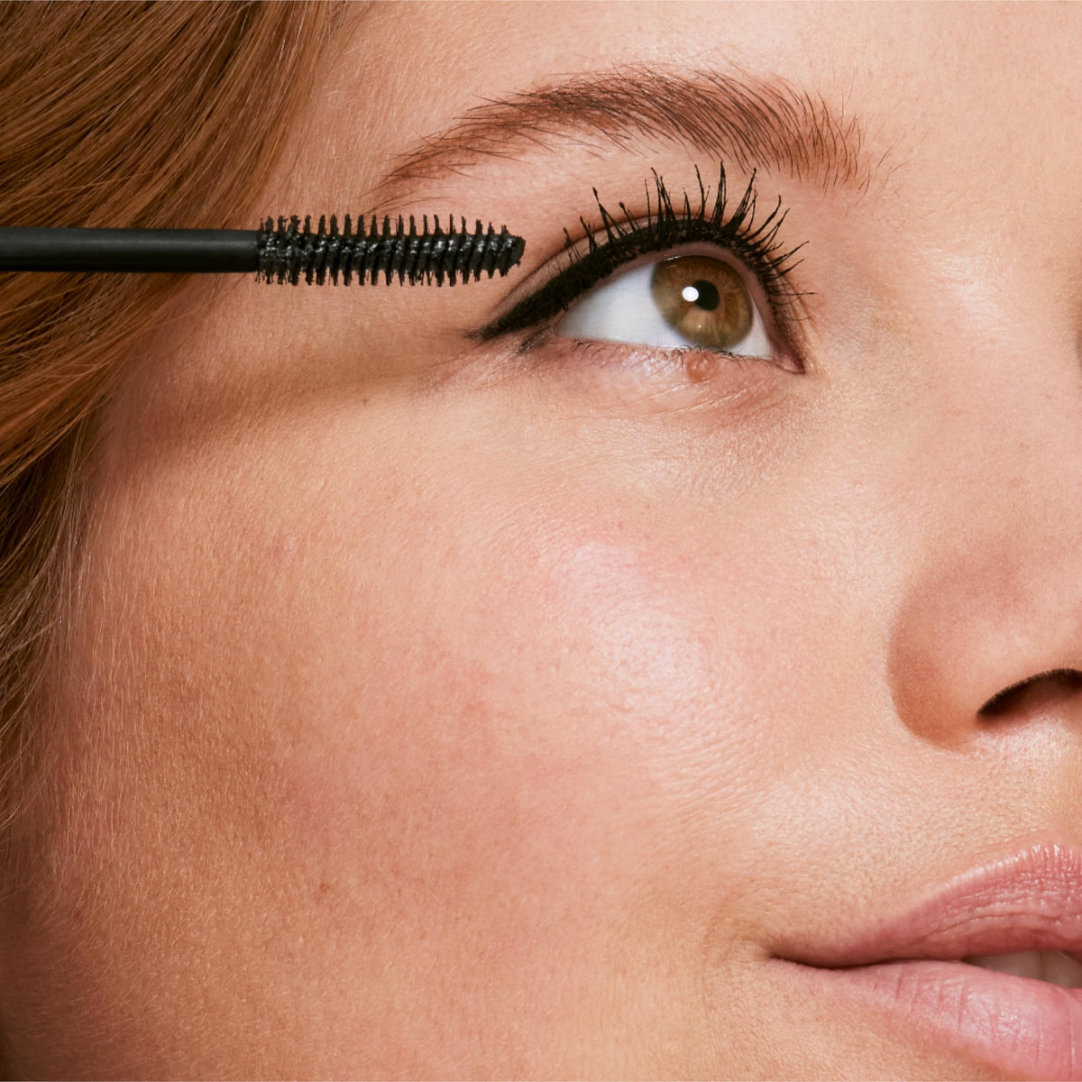 Clinique mascara next to measuring tape showing compact travel size