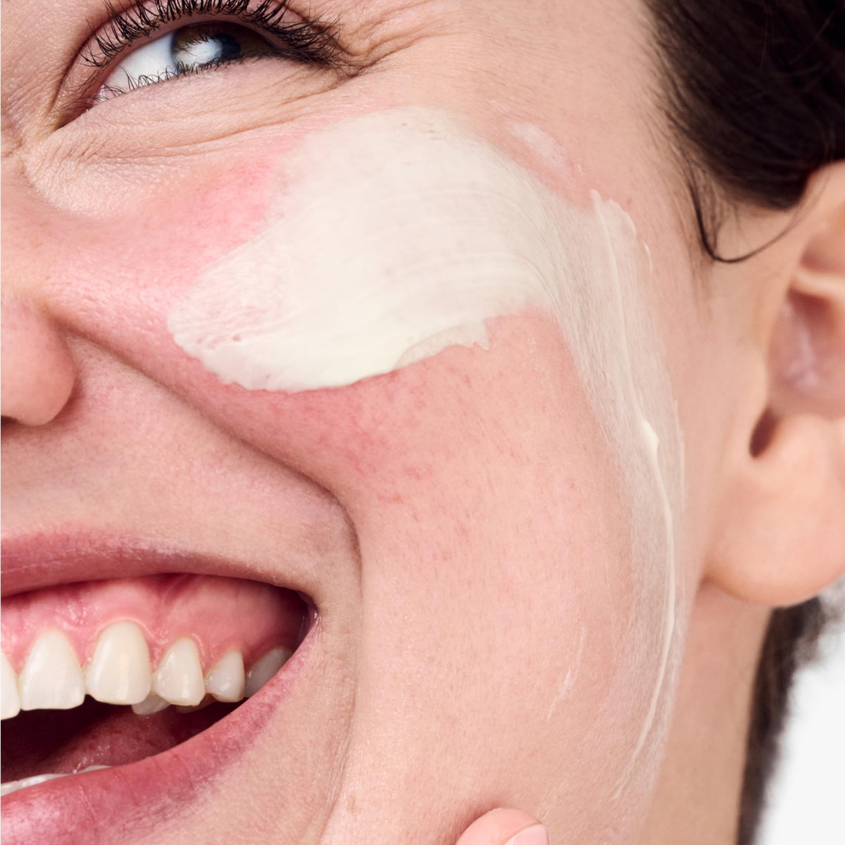 Clinique jar open displaying creamy formula and easy fingertip application