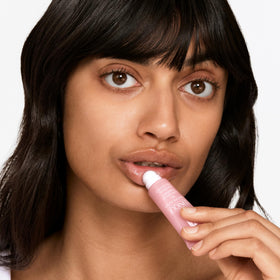 Clinique Moisture Surge Lip applied on hand demonstrating smooth, instant moisture