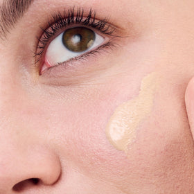 Clinique applied on model cheek demonstrating redness neutralization effect