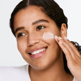 Clinique product held in hand demonstrating travel-friendly 3.4 fl oz scale
