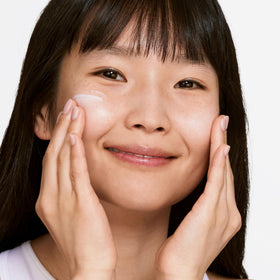 Clinique moisturizer applied to hand demonstrating non-greasy finish
