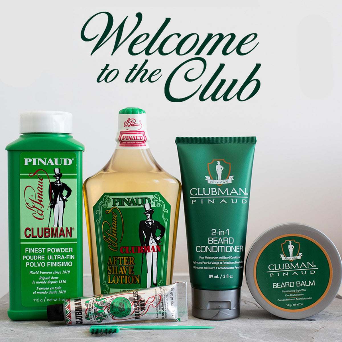 Clubman Pinaud on barbershop counter with razor and towel, suggesting professional grooming results