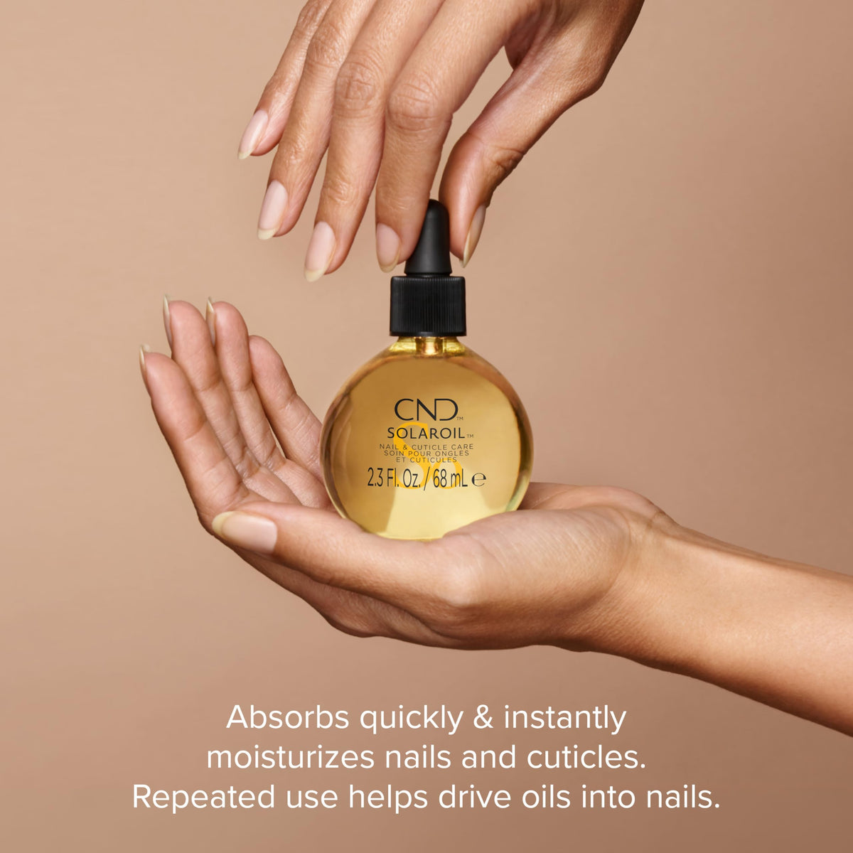 CND SolarOil drop dispensing onto fingertip for precise application