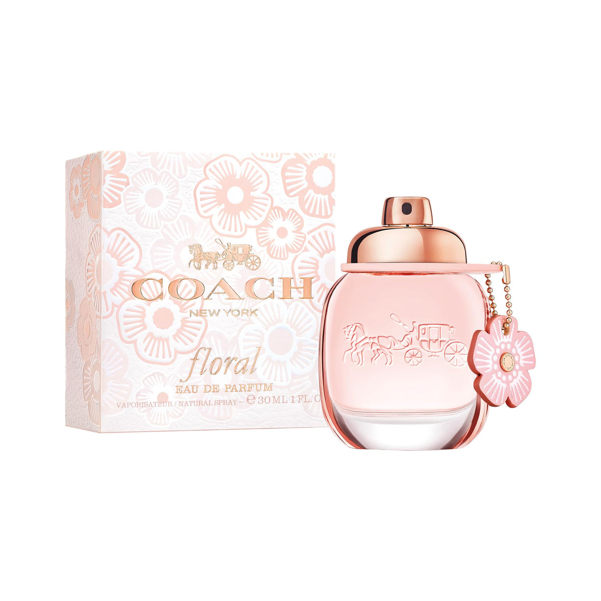 Coach bottle in a sunlit field setting conveying fresh floral mood