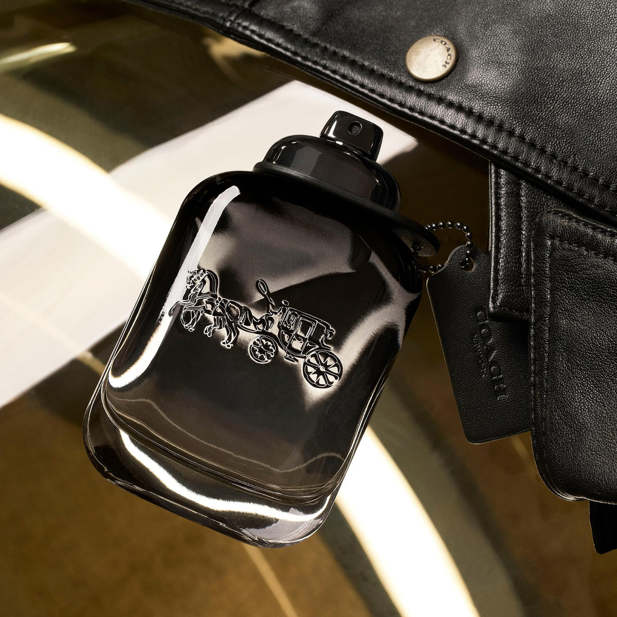 Coach bottle cap and label close-up highlighting premium finish benefit