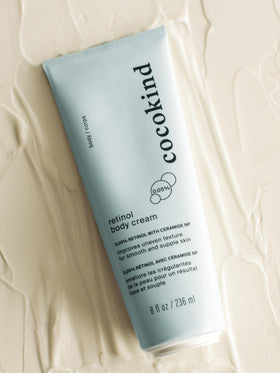 Cocokind retinol body cream on bathroom shelf in a clean skincare routine