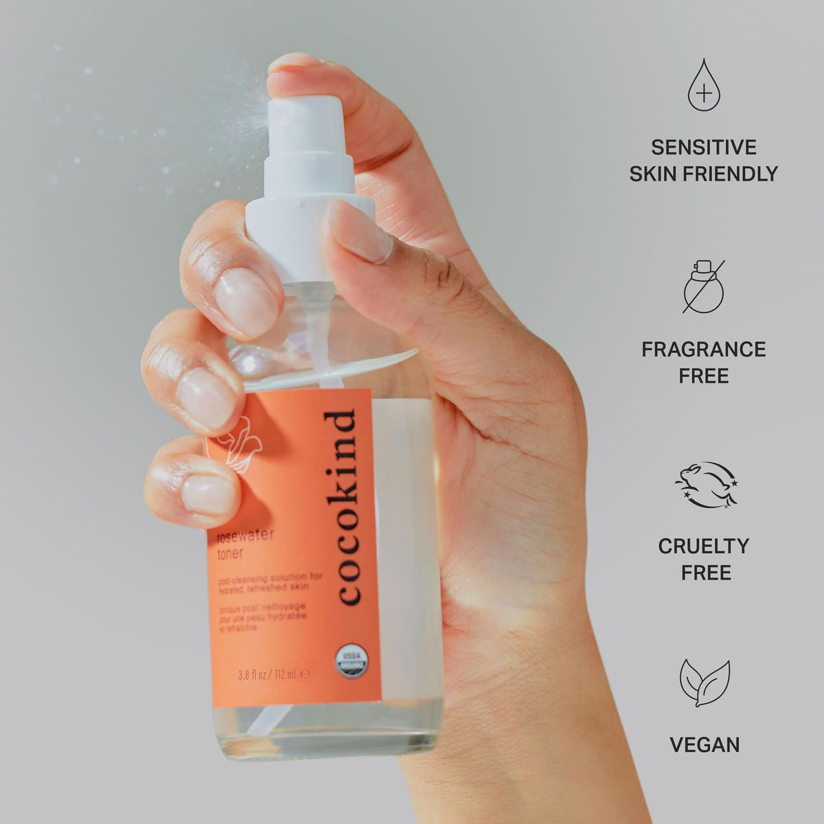 Cocokind rosewater bottle held in hand for size comparison and easy daily use