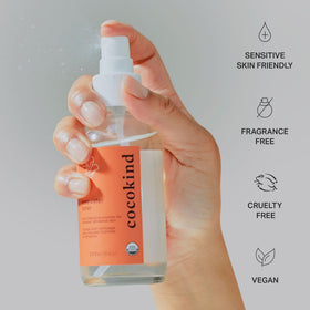 Cocokind rosewater bottle held in hand for size comparison and easy daily use