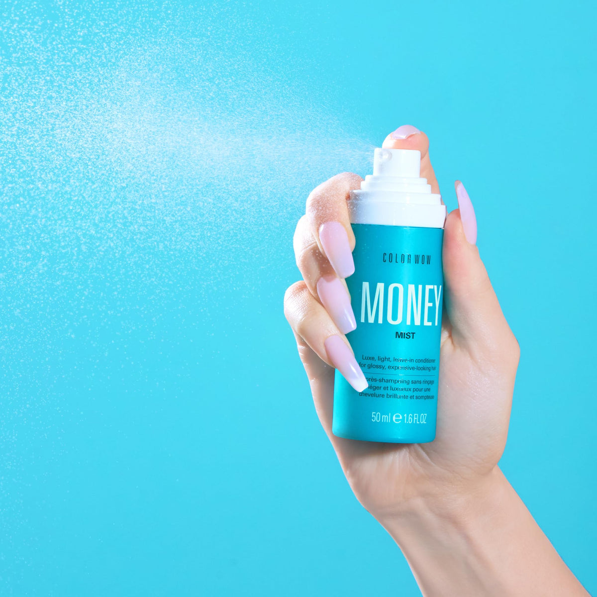 COLOR WOW bottle in hand to show Money Mist size and convenient, portable format