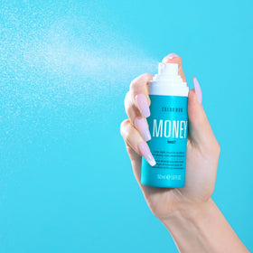 COLOR WOW bottle in hand to show Money Mist size and convenient, portable format