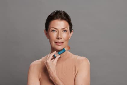 Colorescience brush-on shield bronze in use applied to cheek for on-the-go protection