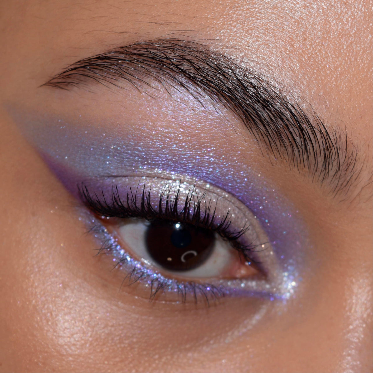 ColourPop palette in use on model eye for bold purple makeup and long-wearing intensity