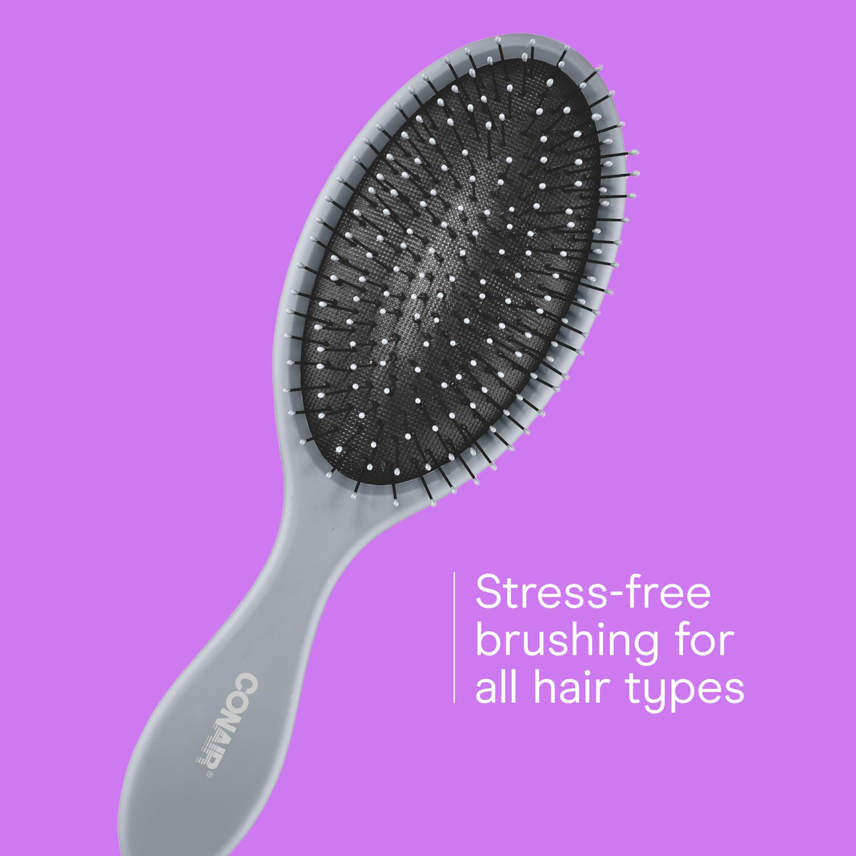 Conair brush in hand scale demonstrating size and comfortable grip for detangling