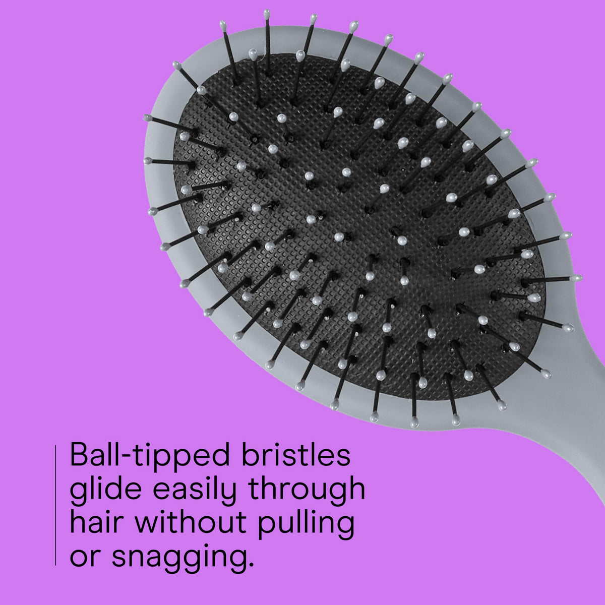 Conair brush in hand demonstrating compact size and easy grip benefit