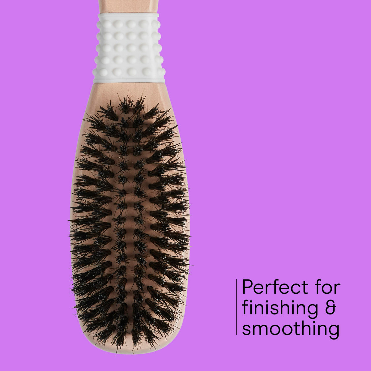 Conair brush held in hand demonstrating ergonomic grip and maneuverability