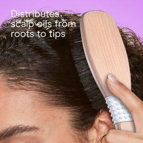 Conair brush placed on bathroom counter suggesting everyday styling routine