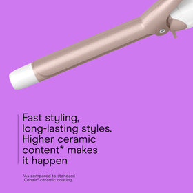 Conair curling iron held in hand showing cool tip for safer handling benefit
