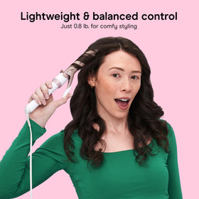Conair curling iron in use on long hair delivering even heat and defined waves