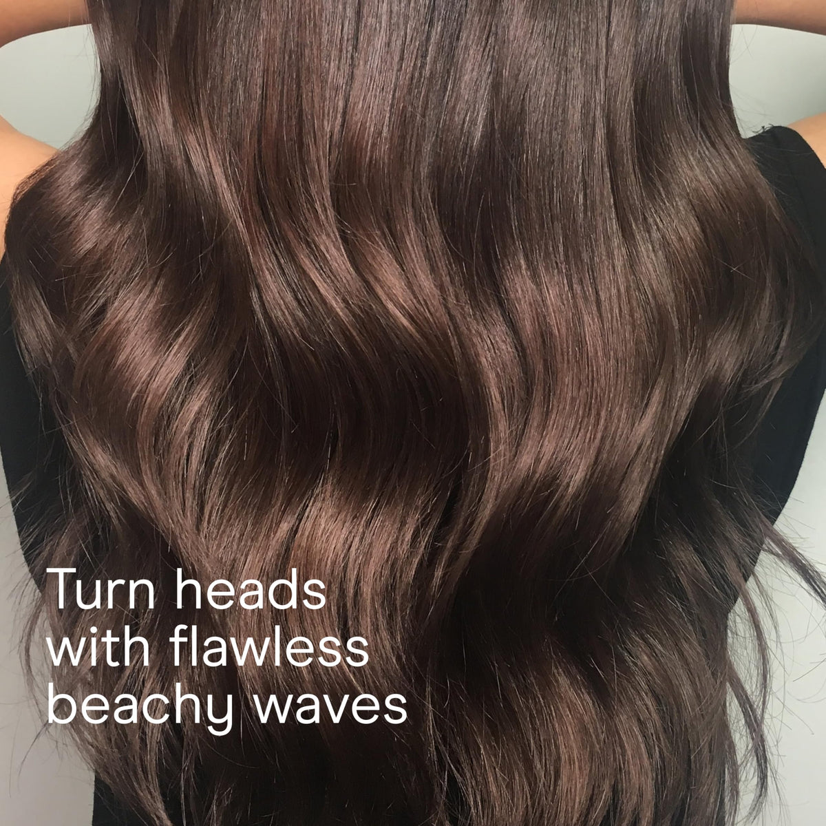 Conair wand creating beachy waves on model demonstrating natural-looking results benefit