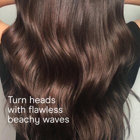 Conair wand creating beachy waves on model demonstrating natural-looking results benefit