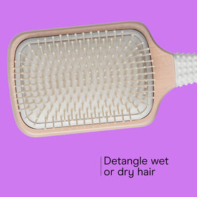 Conair cushioned base side view providing flexible, comfortable brushing
