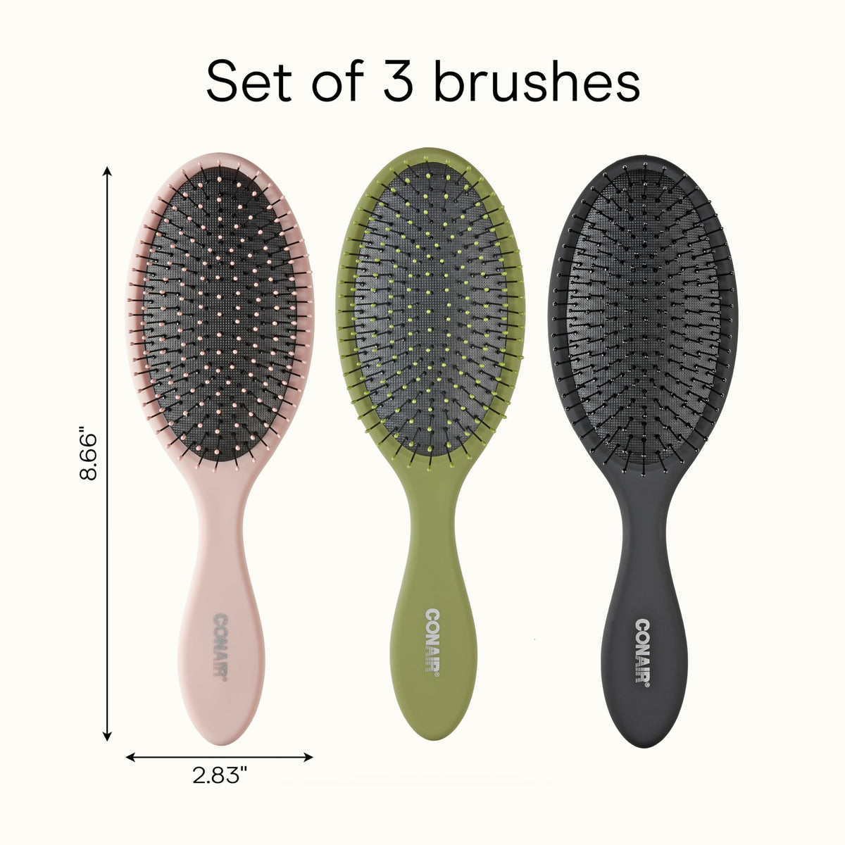 Conair brush next to hand to show compact travel-friendly size