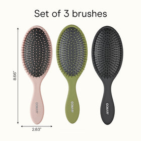Conair brush next to hand to show compact travel-friendly size