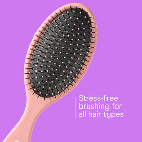 Conair detangler brush used on wet hair to smooth knots after showering