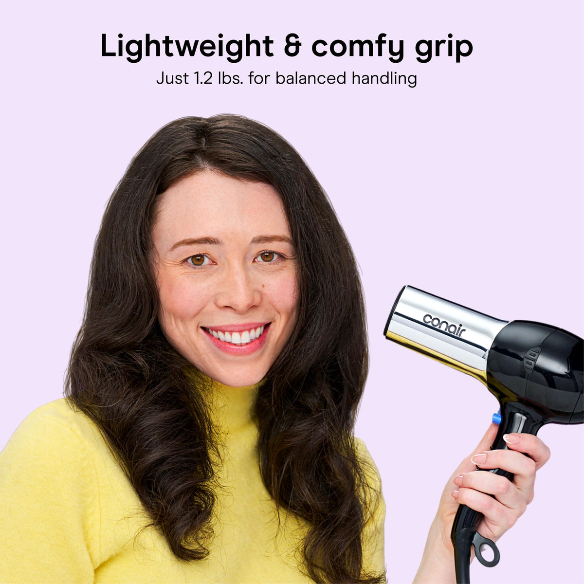 Conair held in hand to show size and comfortable lightweight benefit