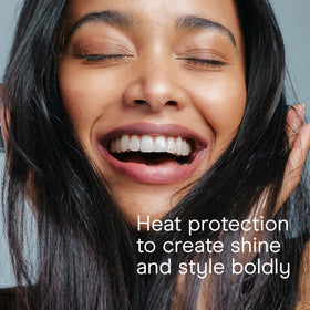 Conair flat iron held in hand to show scale and lightweight design for comfortable use