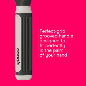 Conair brush held in hand showing scale and easy handling benefit