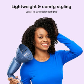 Conair INFINITIPRO held in hand to show lightweight design and comfortable balance