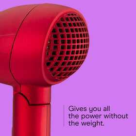 Hand holding Conair Mini Pro demonstrating compact size and comfortable grip